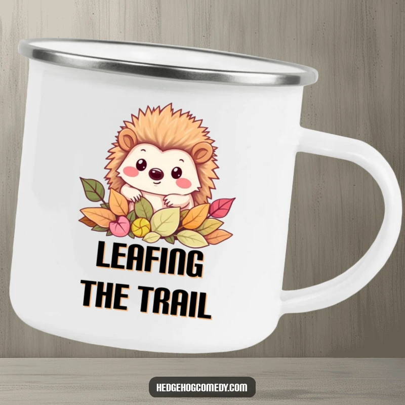 Funny Camping Mug featuring a cheerful Kawaii hedgehog peeking from a pile of leaves, ready for outdoor exploration.