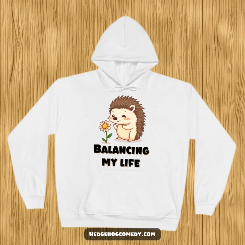 Funny cozy hoodie with a playful hedgehog balancing a small flower, perfect for nature lovers seeking warmth and whimsy.