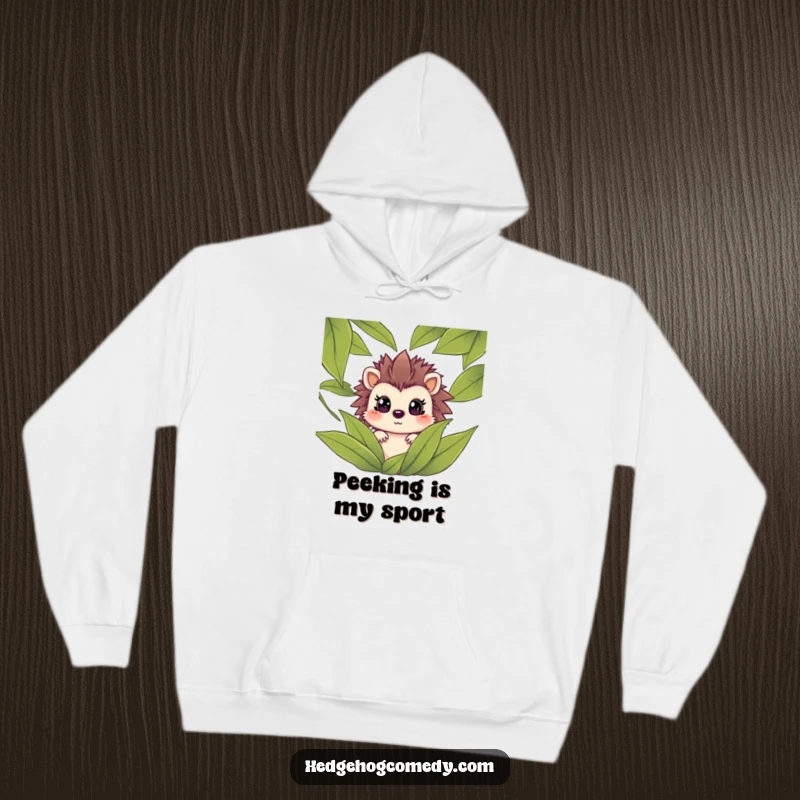 Funny hedgehog peeking from leaves with a surprised face on a cozy hoodie, perfect for screen readers to visualize the humor.
