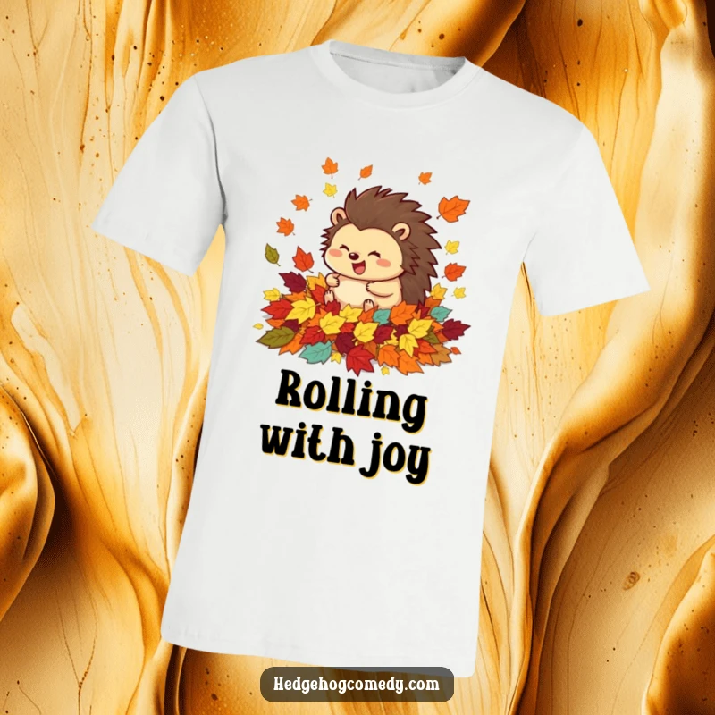 Funny t-shirt depicting a happy hedgehog rolling with glee amidst a beautiful cascade of colorful autumn leaves.